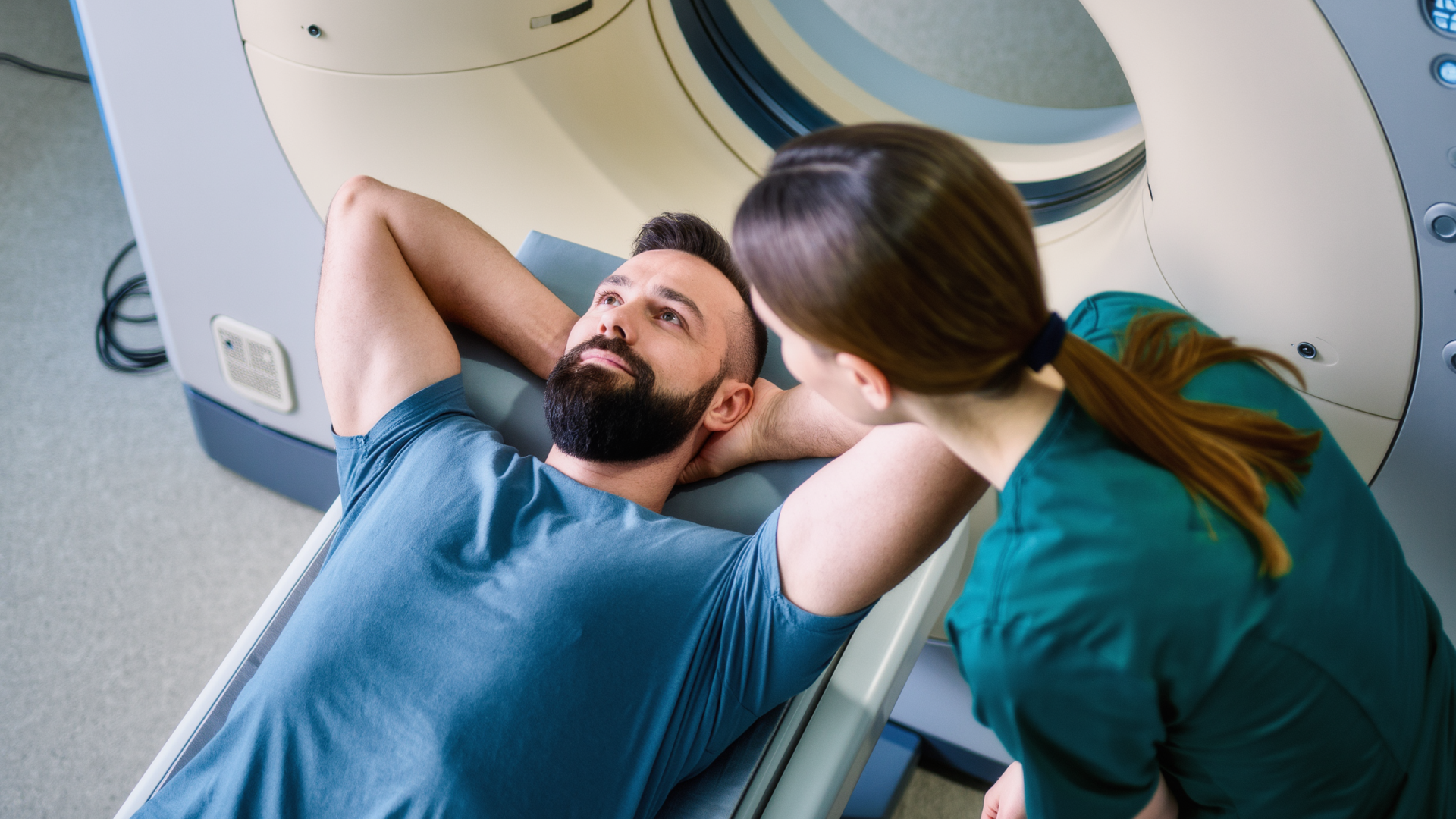 Man having a CT scan with a radiographer, used to detect rare prostate cancer variants