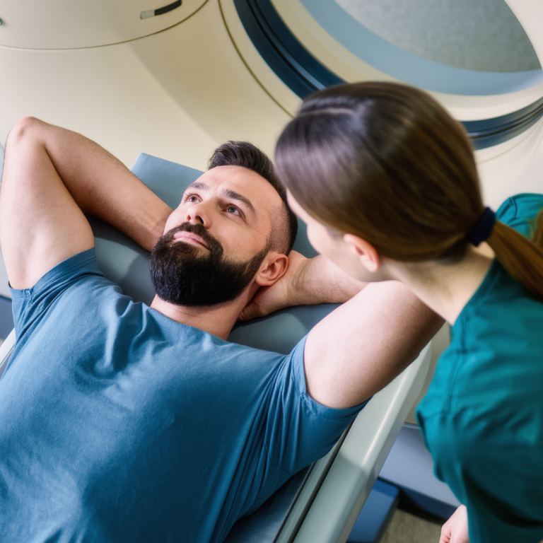 Man having a CT scan with a radiographer, used to detect rare prostate cancer variants