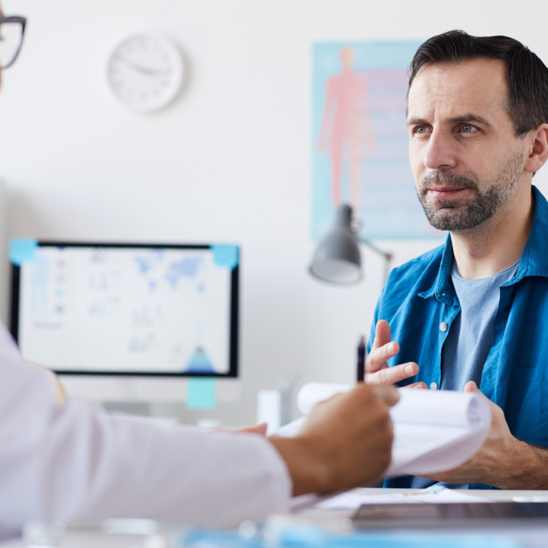 Man discussing Lutetium PSMA therapy options with his doctor during a consultation